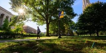 Student by Pitt flag